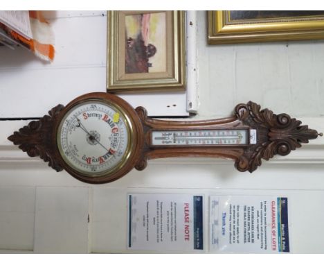 A late Victorian carved oak banjo barometer, with mercury thermometer and aneroid barometer dial, 88cm high