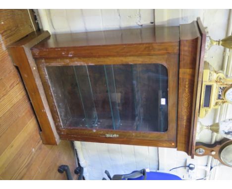 A Victorian inlaid walnut display cabinet, the cavetto frieze over a glazed door with later glazed shelves and velvet interio