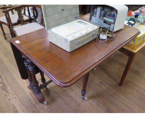 A Victorian mahogany Sutherland table, the rectangular top on baluster turned supports and bracket feet with pot castors, 92c