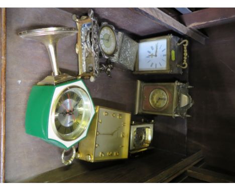 An Edwardian brass timepiece clock, 15cm high and six other table clocks