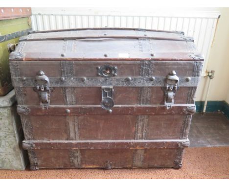 A Saratoga type trunk, the domed lid with wooden slats enclosing two trays, 77cm wide, 57cm deep, 65cm high