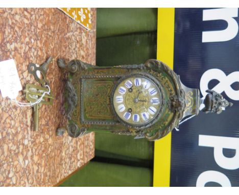 A 19th century French green boullework table clock with all over scroll design, giltmetal dial with enamel chapters and scrol