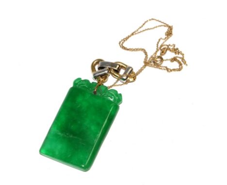 A very fine carved jade pendant set with two colour diamond set stirrups on 18 carat gold chain