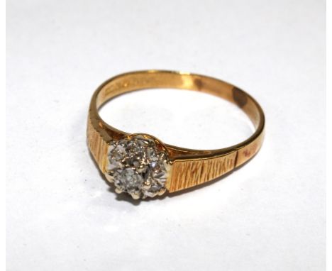 An 18 carat gold ring set with small diamond cluster