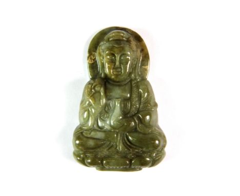 A richly coloured carved Chinese jade amulet of the seated Guan Yin, H. 5.4cm.