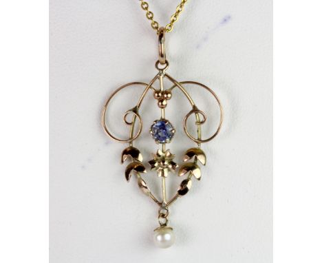 An Edwardian 9ct yellow gold pendant set with a brilliant cut sapphire and a seed pearl on a later 9ct yellow gold chain (sta