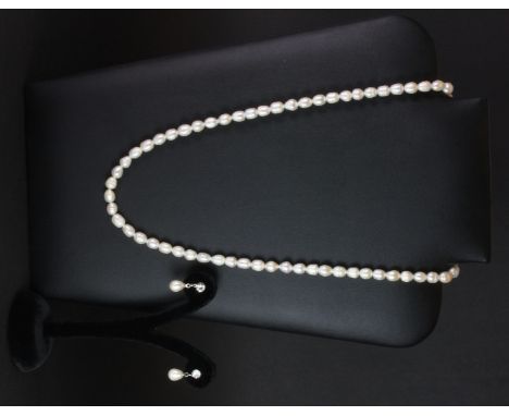 A pearl necklace together with a pair of white metal pearl drop earrings.