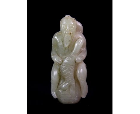 A 19th century Chinese carved nephrite jade figure of a fisherman with his catch, H. 8.5cm.