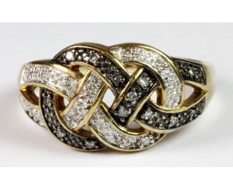 A yellow metal (tested minimum 9ct gold) knot ring set with black and white diamonds (R).