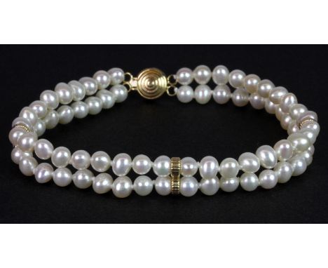 A double row pearl bracelet on a 14ct yellow gold (stamped 14k) clasp, L. 19cm.