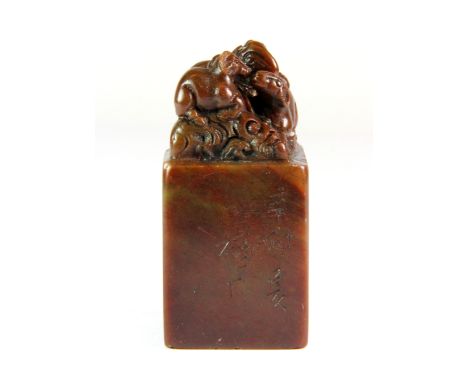 A Chinese mixed colour soapstone seal mounted with rats, H. 7cm.