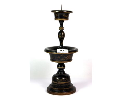 A late Qing dynasty Chinese turned and lacquered wood candlestick, H. 32cm.
