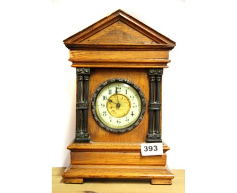 A 19th century oak classical mantle clock, H. 30cm.