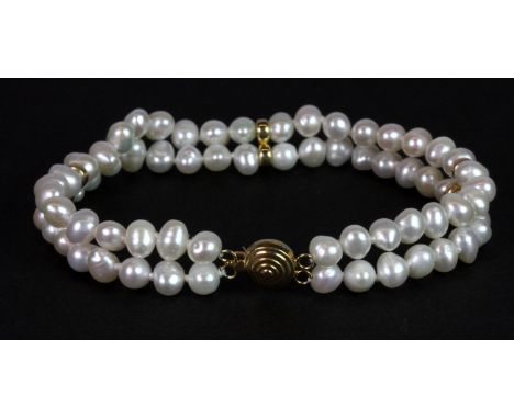 A double row pearl bracelet on a 14ct yellow gold (stamped 14k) clasp, L. 19cm.