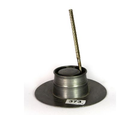A 19th century pewter inkwell and a cast iron boot jack.