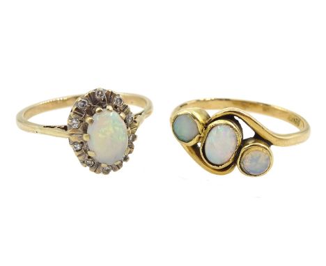 Gold three stone opal ring, stamped 18ct and a 9ct gold opal and diamond cluster ring