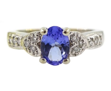 White gold oval tanzanite ring, with diamond set shoulders, stamped 14K