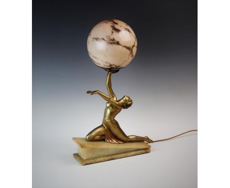 An Art Deco figural desk lamp, the gilt metal lamp modelled as a 1930's dancer, with arms aloft, mounted upon a wedge shaped 