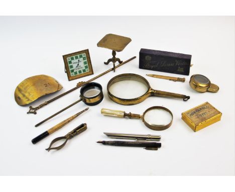 A brass railway porters armband impressed' R.U.D.C Town Porter No. 21 Rhyl', 14cm long, a brass framed magnifying glass, 11cm