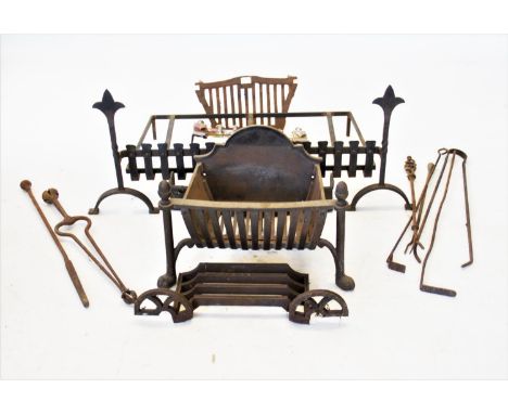An Arts &amp; Crafts style wrought iron fire grate, 105cm wide, with a cast iron fire basket and a selection of assorted fire