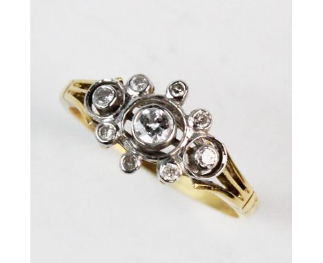 A diamond set 18ct gold cluster ring, comprising, a central brilliant cut diamond weighing approx. 0.10ct, with a halo surrou