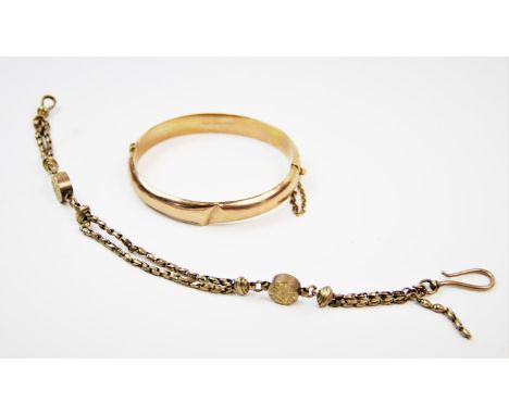 A 9ct gold hinged bangle, Birmingham 1942-43, with foliate relief design, bayonet clasp and safety chain, with a further fanc