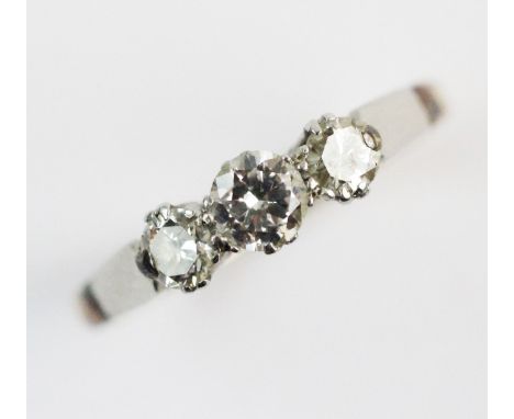 A three stone diamond ring, the central round brilliant cut diamond measuring approx. 0.20ct, with a further brilliant cut di