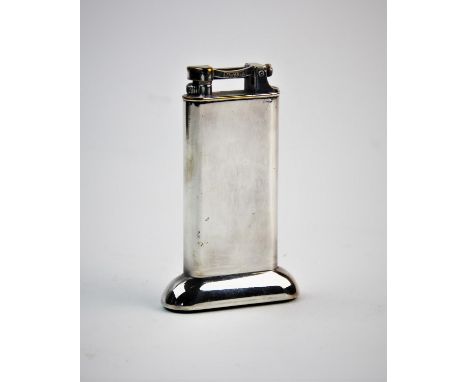 A 20th century silver plated Dunhill petrol table lighter, of typical plain polished form, 10cm high 
