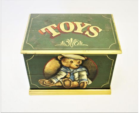 A painted pine toy trunk, the hinged cover painted with text 'Toys' and the front panel painted with a Teddy bear, raised upo