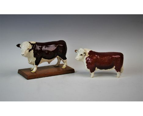 A Beswick model of a Red Hereford bull 'CH of Champions' and a second similar model mounted upon a later hardwood plinth (2) 