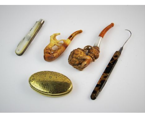 A selection of early 20th century smoking items, comprising: a miners brass snuff box, of lozenge form, decorated with star m