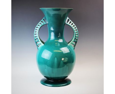 In the manner of Christopher Dresser, a Linthorpe pottery vase of large proportions, the turquoise glazed vase of baluster fo