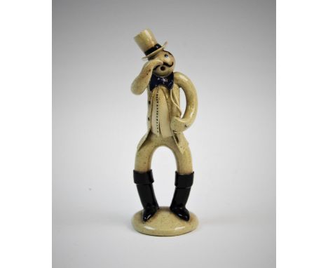 A Burslem School Of Art studio pottery figure, modelled as a circus ringmaster with top hat, bow tie and whip, impressed 'BSA