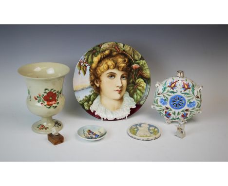 An Arts and Crafts decorative wall plate, late 19th century, the plate hand painted with the portrait of a young lady set aga