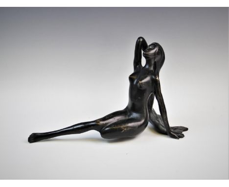 A bronzed model of a reclining nude, 24cm high, an early 20th century Art Nouveau brass framed wall mirror, the rectangular f