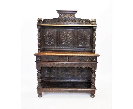 A Victorian carved oak buffet/sideboard, the three panel back carved with flower heads below a shelf supported on a pair of c