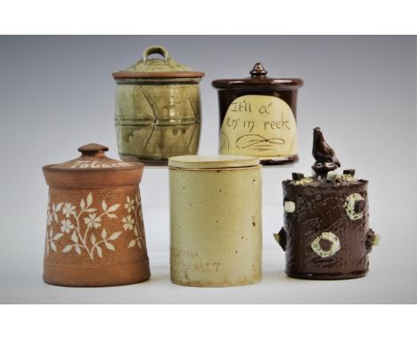 A treacle glazed stoneware tobacco jar and cover, late 19th or early 20th century, the cylindrical jar with rolled lip and sl