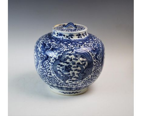 A Chinese Kangxi style blue and white jar and cover, 19th century, of bulbous form, decorated with recurrent motif of a drago