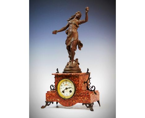 A late 19th century French rouge marble mantel clock, the 8cm ceramic dial adorned with a floral spray and indistinctly signe