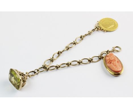 A yellow metal bracelet with assorted charms, the mixed link bracelet stamped '9ct' measuring approx. 18cm, spring ring faste