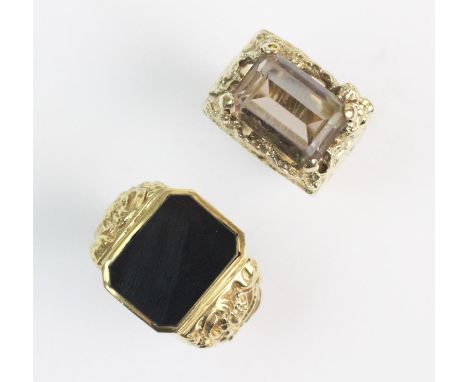 A smokey quartz set 9ct gentleman's dress ring, the central step cut quartz measuring 10mm x 14mm, claw set to a textured tap