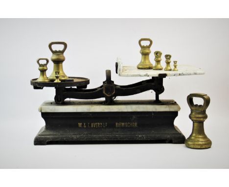 A set of early 20th century W T Avery butchers scales with weights, the scales with a veined marble platform upon an ebonised