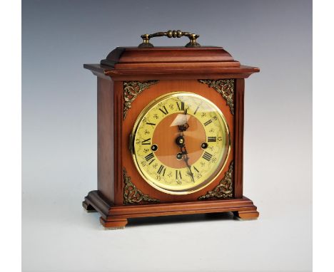 A West German Lauris chiming mantel clock, the rectangular case enclosing a circular face with a Roman numeral chapter ring, 