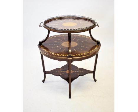 An Edwardian mahogany etagere, of oval form with a removable glass tray, the two graduated tiers inlaid with a central oval s