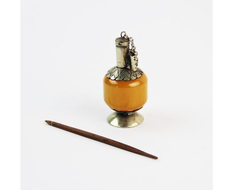 A Chinese white metal mounted 'butterscotch' amber scent bottle, with compressed baluster body, to spreading foot rim, stylis