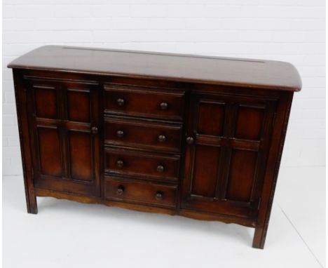 An Ercol dark elm sideboard, the rectangular top over three central drawers and pair of panelled cupboard doors, 90 x 146cm