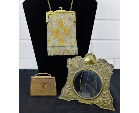 An Art Nouveau brass photograph frame, 14cm high together with a mesh change purse and a vintage gilt metal powder compact (3