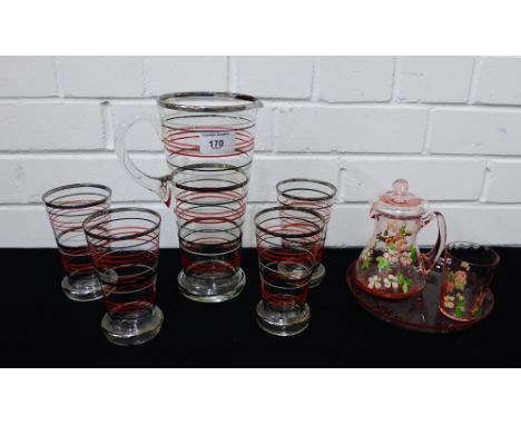 A retro glass lemonade set with red, white and black striped decoration comprising, jug and four beakers, together with a vin