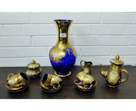 A blue glass teaset, painted with floral enamelled decoration and gilt highlights, comprising six cups, six saucers, a teapot