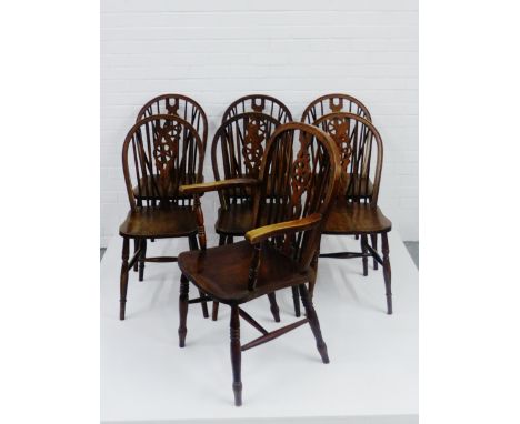 A set of six Ercol style wheel back dark oak chairs together with a matching carver 90 x 40cm (7)